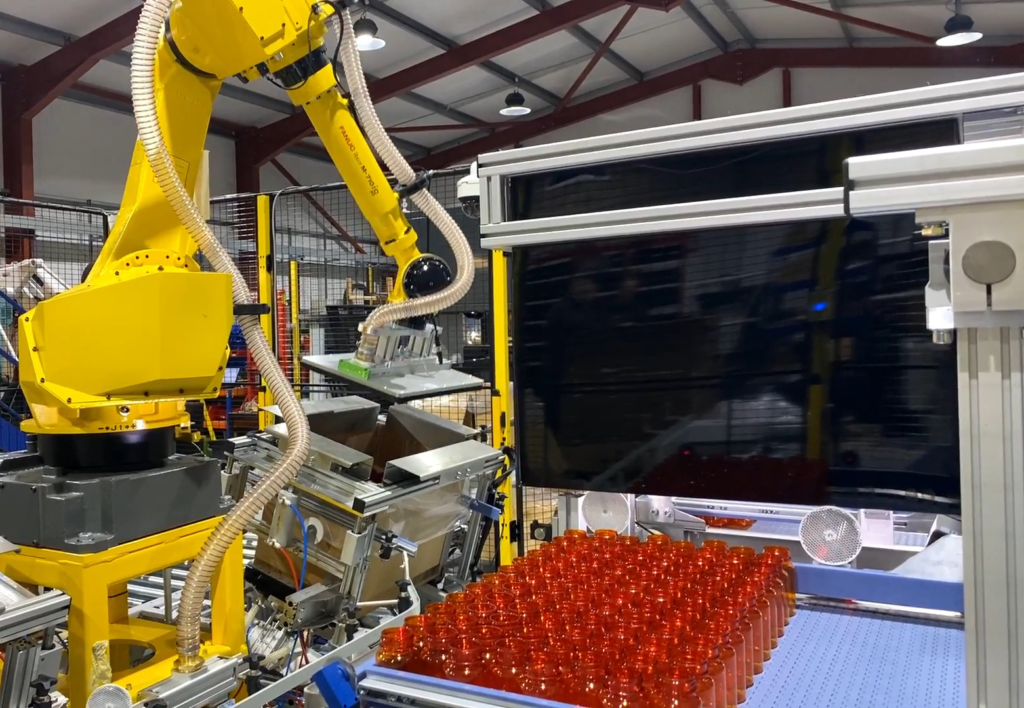 Robotic box erector, box liner and pill bottle packing system
